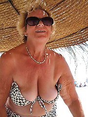 Smiling cougar having unshaved twat